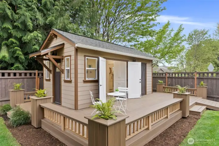 Shop deck features custom planters, adding charm and curb appeal