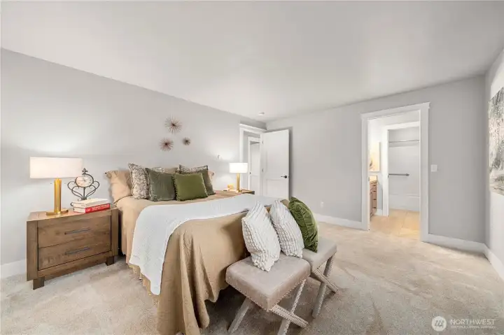 Primary bedroom with bath door showing in this photo