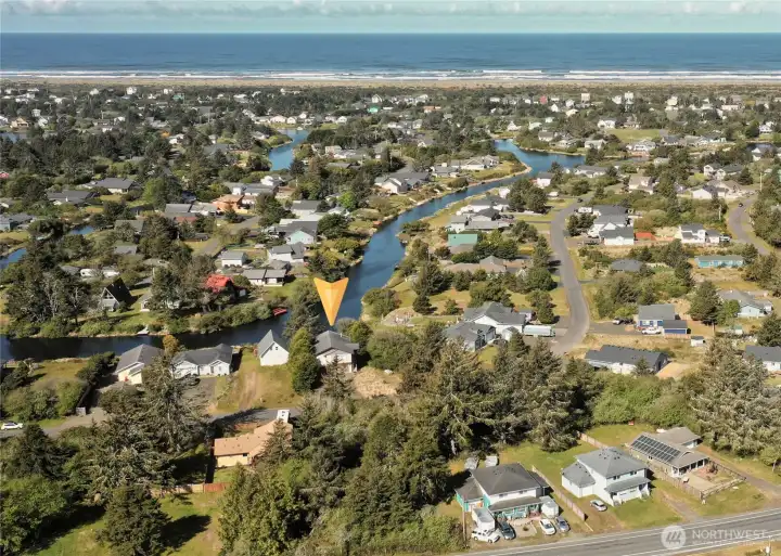 Aerial photo showcases the   expansive layout of 137 N Razor Clam Dr SW,   nestled along the Bell Canal in Ocean   Shores, WA. The property boasts direct canal   access, offering unparalleled opportunities   for boating, kayaking, and enjoying serene   waterfront living