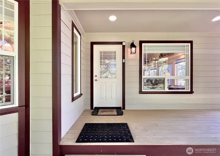 THE MAIN ENTRY of the Home, Showcasing Warm   Ambient Lighting and a Discreetly Integrated   Security System for Enhanced Comfort and   Safety