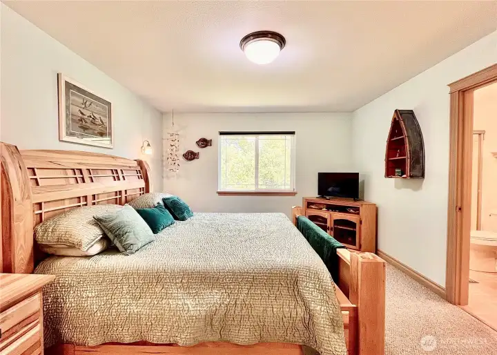 Spacious Primary Bedroom Featuring   High-Quality Furniture That Conveys with the   Home. This Elegant Room Includes a Large   En-Suite Bathroom and a Huge Walk-In   Closet, Offering Ample Storage and Comfort   for a Luxurious Living Experience.