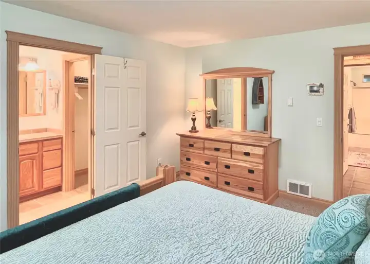 View from the Primary Bedroom,   Highlighting the Large En-Suite Bathroom,   Expansive Walk-In Closet, and the Door   Leading to the Hallway. The Layout Offers a   Tranquil and Quiet Retreat, Just Steps Away   from the Kitchen for Ultimate Convenience.