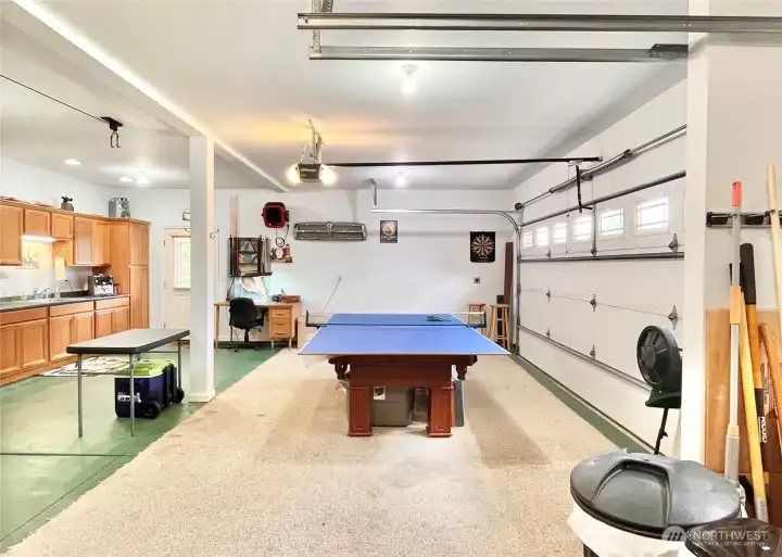 A Generously Sized, Triple-Car Garage with   Automatic Doors, Designed for Ultimate   Functionality and Entertainment. This Room   Offers Ample Space for a Rec Room, Pool   Table, or Customizable Gear Storage. With a   Built-In Cabinet and Sink, It’s Perfect for   Preparing the Fresh Catch of the Day,   Grabbing a Cold Drink, Listening to Music,   Working on a Project, or Creating the   Ultimate Hangout Spot for Relaxation and   Fun.