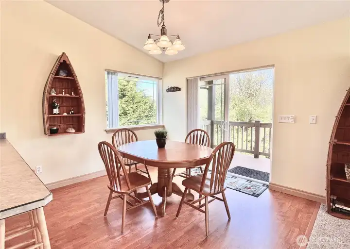This thoughtfully furnished upstairs dining   room offers a seamless blend of comfort and   style. Large windows frame picturesque   views of the Bell Canal, bathing the room in   natural light and providing a serene   backdrop for meals and gatherings.