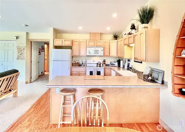 Separate Living Area - This upstairs apartment features a functional   kitchen with modern appliances and ample   counter space. View of the door leading   directly to the adjacent bedroom, enhancing   the apartment's efficient design. Whether   you're preparing a quick meal or enjoying a   leisurely breakfast, this kitchen provides both   comfort and convenience.