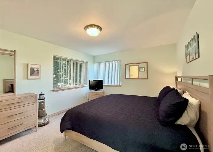 Expansive upstairs bedroom offers   ample space and is thoughtfully furnished,   with quality pieces included in the sale.   Large windows provide southern-facing   views of the Bell Canal, filling the room with   natural light and offering tranquil water   vistas. The clean, airy ambiance makes it an   ideal space for relaxation or hosting guests.