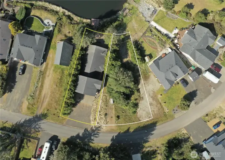 Approximate property boundaries of 137 N   Razor Clam Dr SW, situated along the Bell   Canal in Ocean Shores, WA. Adjacent to this   property, the neighboring lot at 138 N Razor   Clam Dr SW is available for purchase at   $100,000