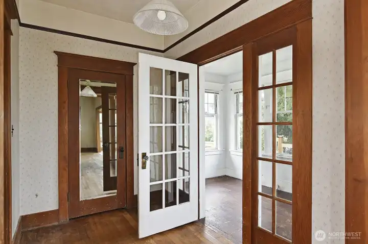 French doors to enclosed sitting room for peaceful reading or a quiet visit with your company. A good sized coat closet center left, and to the left is the door to the formal dining room.