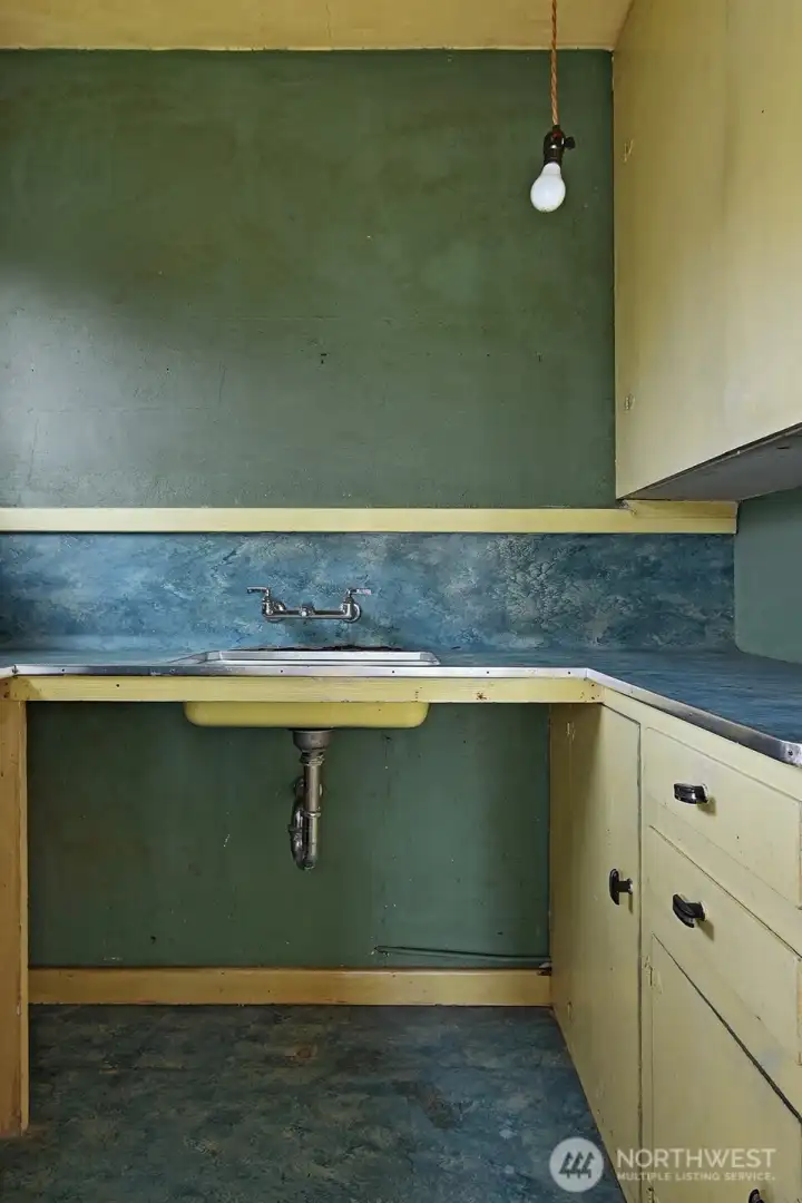 The “dark room” off the pink bedroom. Perhaps an additional bathroom?