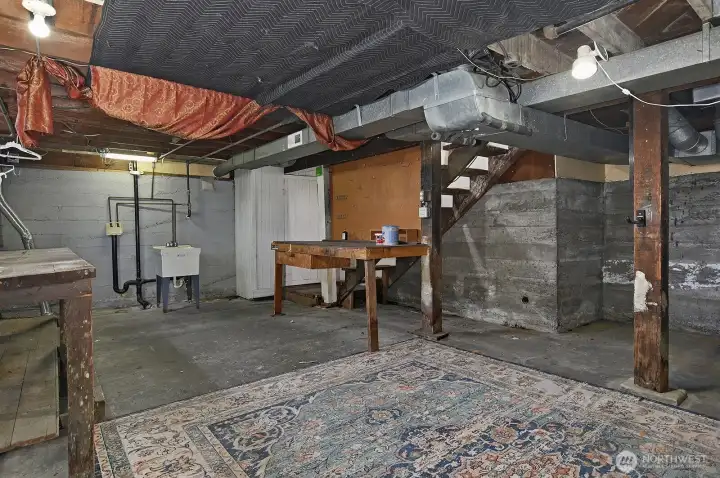 The unfinished yet dry basement with decent ceiling height.