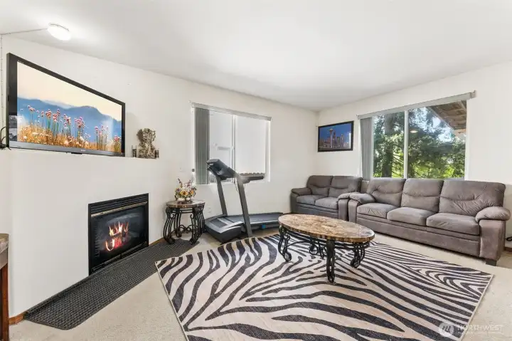 Cozy family room featuring a fireplace as the focal point.