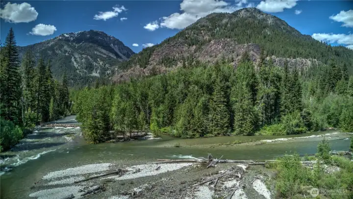 Confluence of the Methow and the Lost River encircle this magnificent offering of 20 plus acres of riverfront.