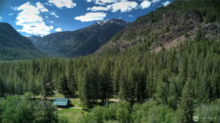 Set at the gates of vast wilderness, North Cascades National Park, Okanogan National Forest and Pasayten Wilderness surround this home and land as the two most northern offering in Methow Valley.