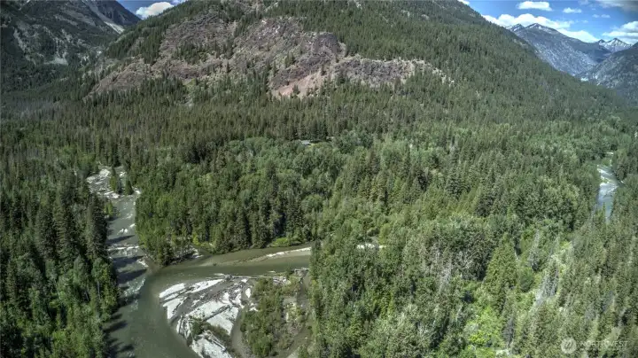 Arial shows the home surrounded by pristine wilderness, but this home lies just minutes off a flat paved road, and has super easy year round access which is difficult to find.