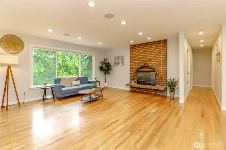 The perfect blend of character and comfort with a brick fireplace insert, oversized windows, and rich hardwood floors.