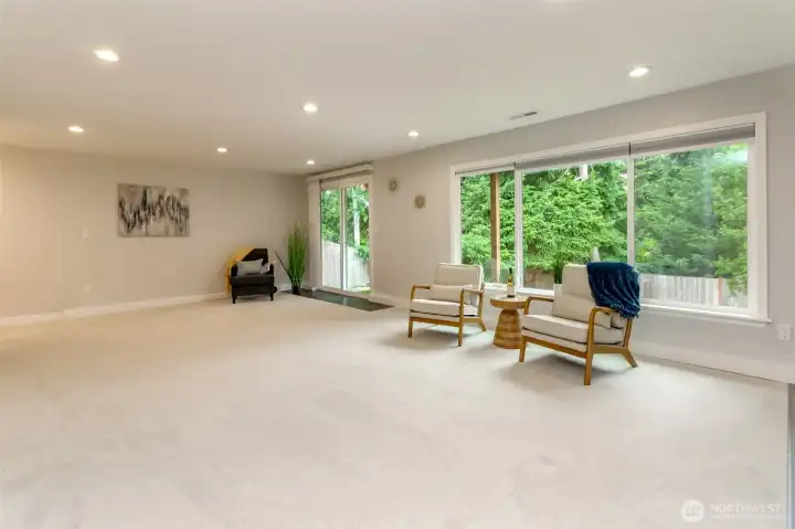 A versatile lower-level family room with direct patio access for relaxing or entertaining