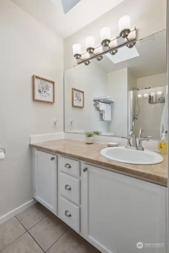 Here's one side of the primary bath showing the vanity with ample storage.