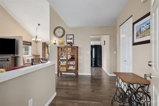 As you step into the entry, the living room is to the left with the kitchen and dining room straight ahead. To the right is the door to the laundry room, and out to the garage.