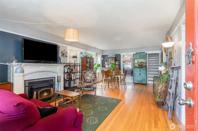 Enter into the living room, where natural light and a welcoming atmosphere greet you.