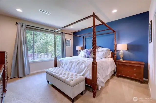 Spacious main-floor primary bedroom features a walk-in closet and 5-fixture bath.