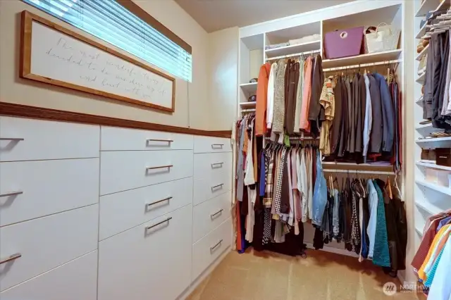 Large walk-in closet with custom California Closet features.