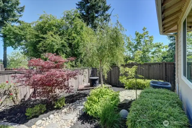 Beautifully landscaped back yard features another deck for quiet, peaceful enjoyment.