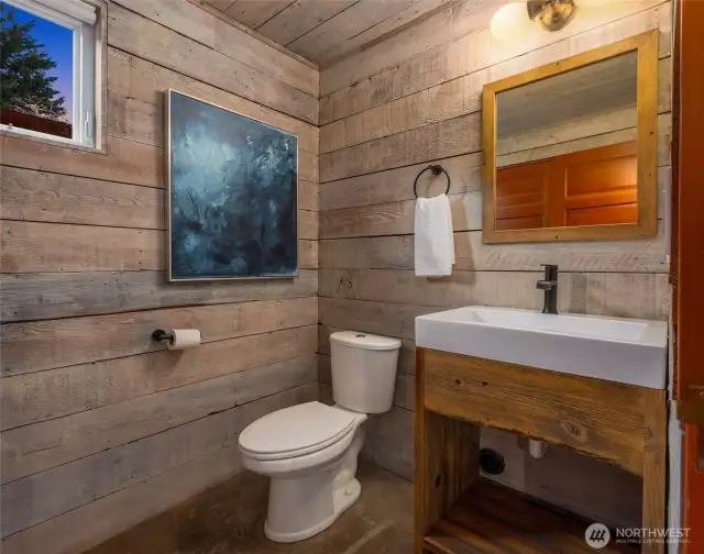 The main level of the home also includes a convenient powder room, with classic fixtures, and abundant storage under the stairwell.