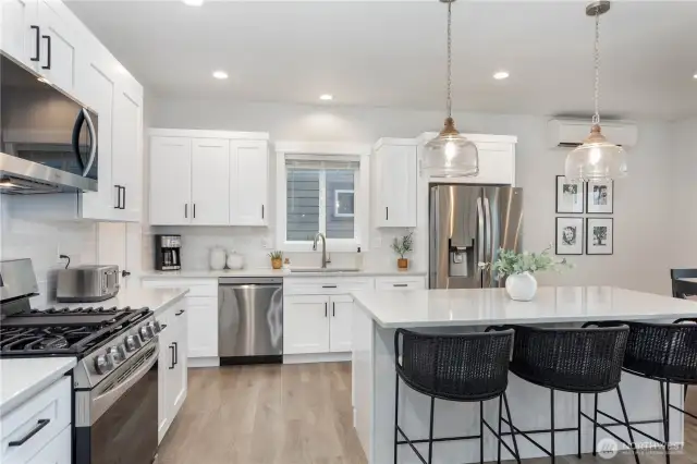Stainless Steel appliances with a gas cooktop and oven.