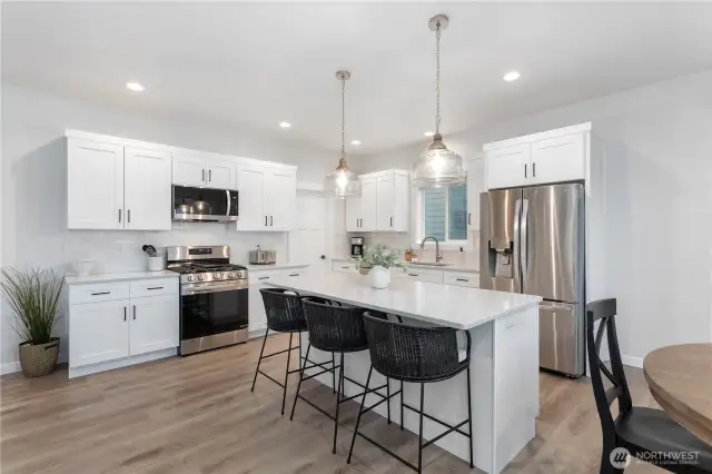 Very functional kitchen with a lot of storage space.  The closed door is the entrance to a walk-in pantry.