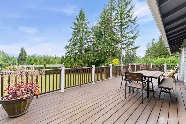 The deck runs the full length of the house and overlooks the half acre of property