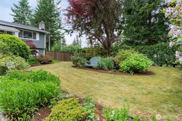 Gorgeous, mature, landscaping makes the front yard look like a park