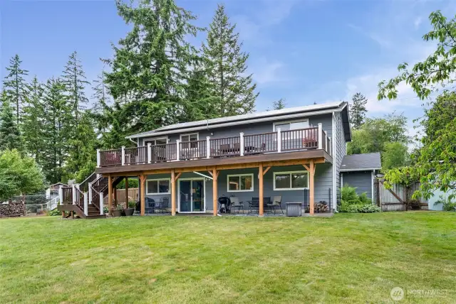 The backside of the house features a completely covered patio on the lower level with the drainage system