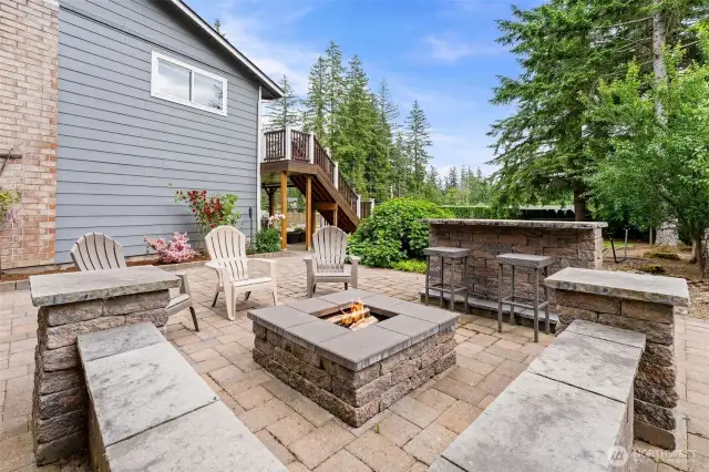 Custom fire pit and brick patio. Built-in bench seating plus bistro table and bar height stools.