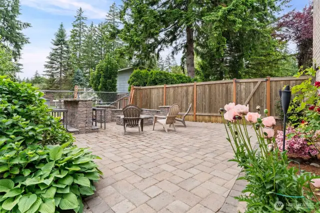 Inside the fenced backyard. Gather around the fire pit. S’mores anyone?