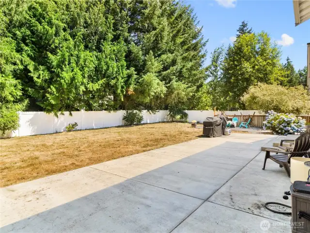 Newer concrete patio and all new white vinyl fencing