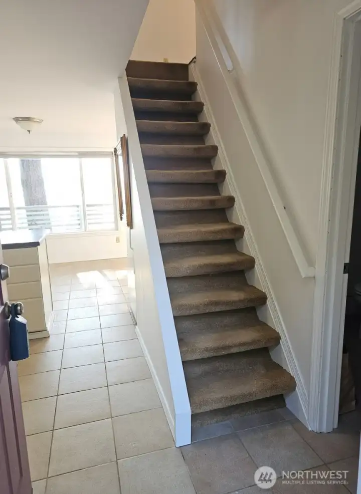 entry leading into kitchen and upstairs to both bedrooms. 3/4 bath with laundry on right
