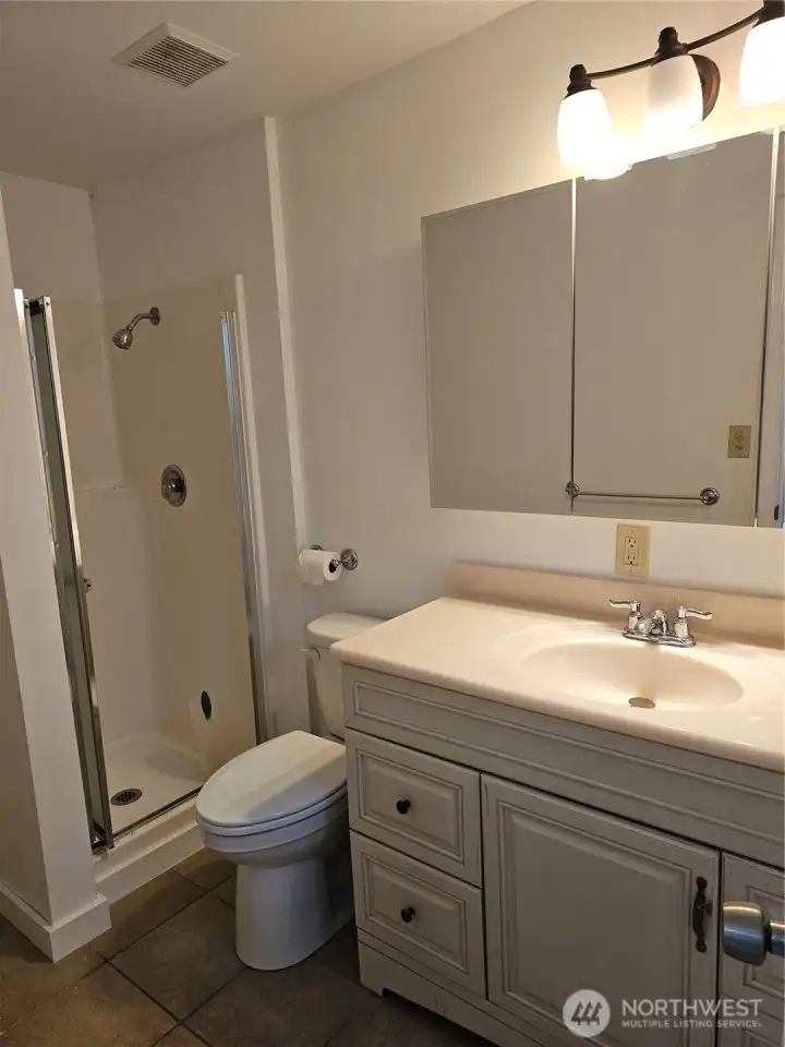 main level 3/4 bath with stackable laundry hookups