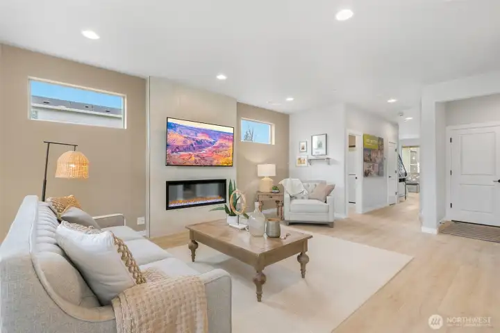 Spacious and open living room centered around cozy electric fireplace and full height tile surround. TV is also included!