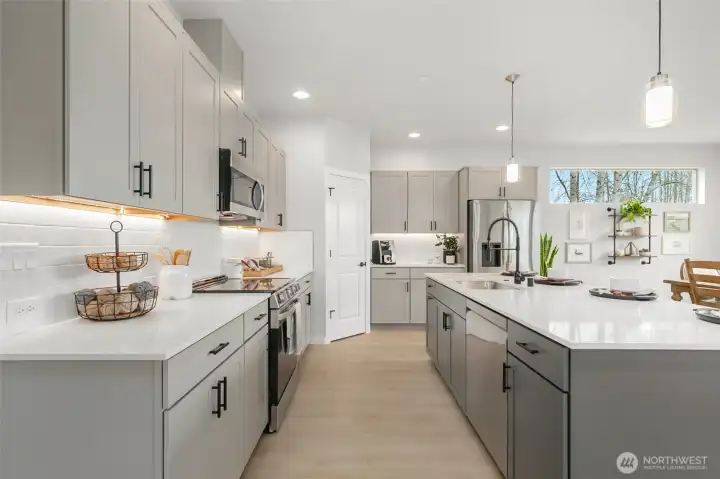 Contemporary kitchen with undercabinet lighting really brightens up the workspace!