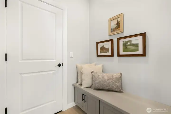 Entering your home from the garage, the thoughtfully designed mudroom with a built-in bench makes for the perfect drop zone.