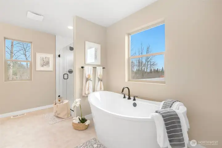 Gorgeous freestanding tub and the tile surround in the walk in shower adds to the beauty of this primary bath.