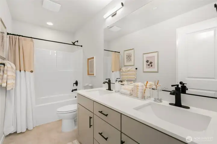 Shared hall bath also boasts dual sinks with undermount sinks & quartz countertops.