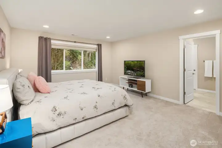 Private primary bedroom is oversized, easily fitting a King bed, side tables, dresser and more