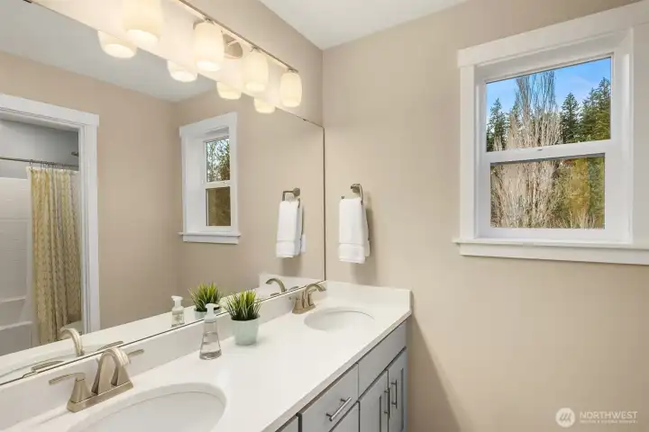 Four piece bath with Quartz counters, undermount sinks, Shaker cabinetry and separate shower/toilet room along with linen closet