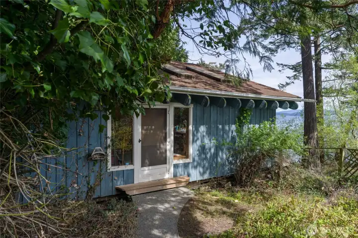 Separate shoreline studio/cottage has lots of potential.