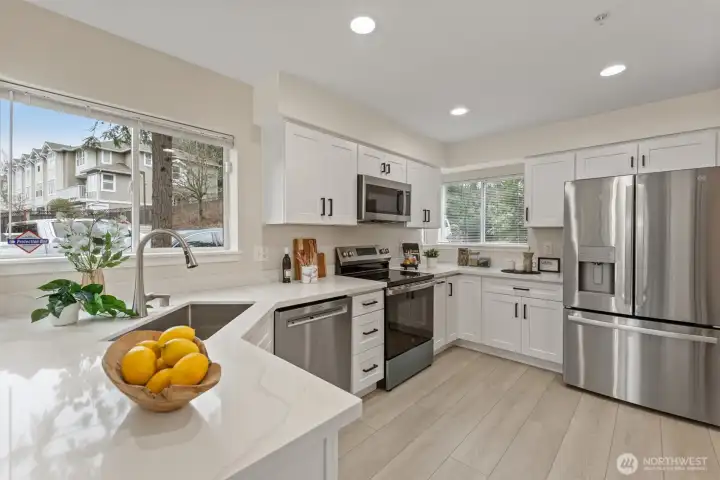 Gorgeously renovated kitchen with new SS appliances, cabinets, quartz countertop and flooring.