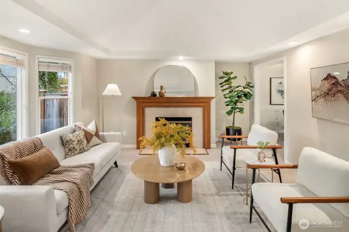 A timeless layout welcomes you with a light-filled living room featuring vaulted ceilings and a bay window overlooking blossoming trees and lush landscaped grounds.