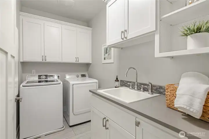 The upstairs laundry room with a handy sink and good extra storage.