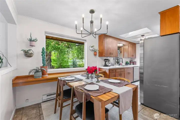 Dining area window overlooks lush, private backyard.