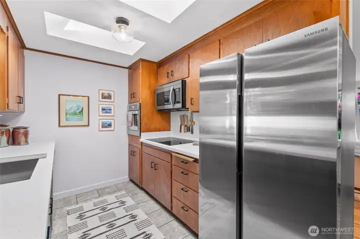 2023 appliances & two skylights flooding the kitchen with wonderful light.